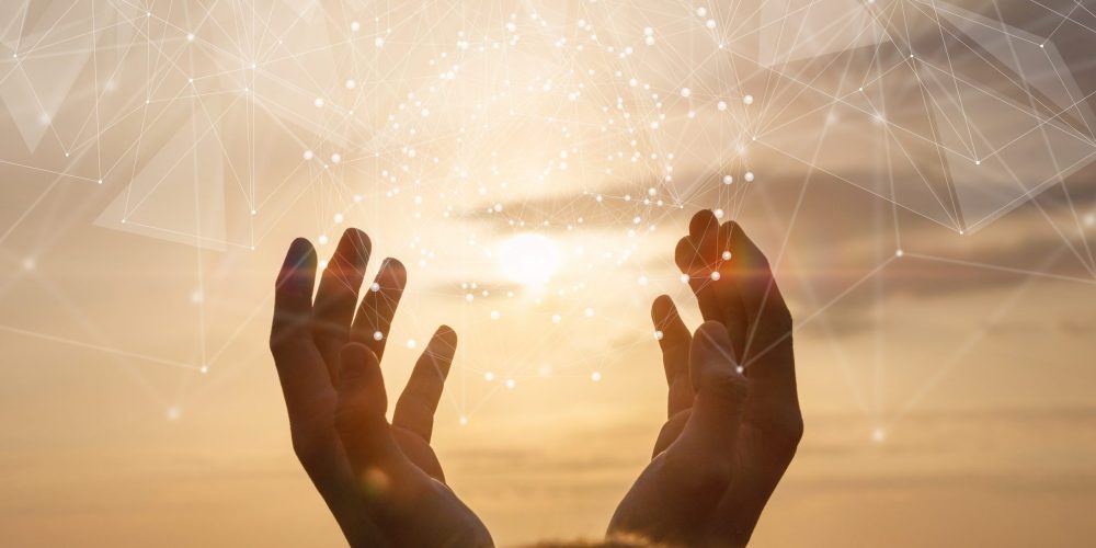 The concept of integration network . Hands is in contact with a virtual network on a background of sunny sunset.